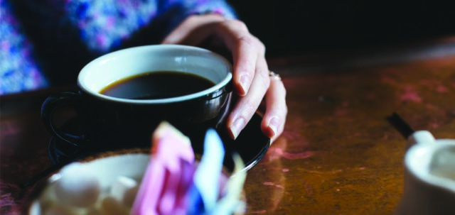 Holding onto a cup of coffee